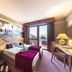 Villa Fiorita room in Monastier di Treviso with double bed, mural wall art and balcony view