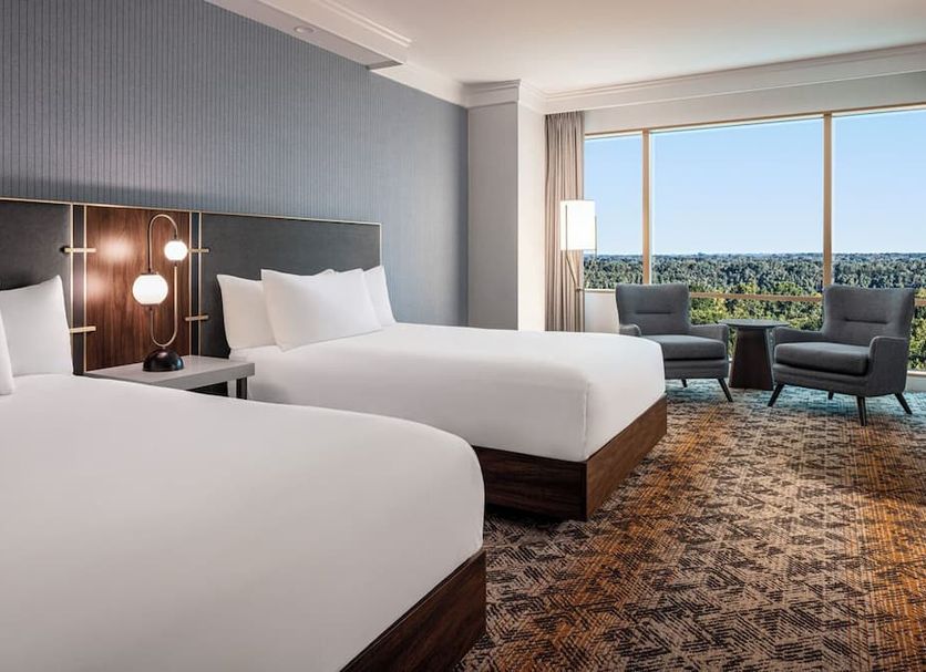Horseshoe Tunica guest room with two beds and floor-to-ceiling window overlooking Tunica Resorts