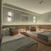 Hotel Bavaria Blu in Mamaia guest room with twin beds, wall lights and a wooden bunk bed frame