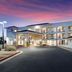 Red Roof Inn Albuquerque - Midtown exterior at dusk with arched balconies and illuminated entrance
