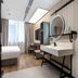 Hanting Hotel Guangzhou Zhongshanba Metro Station room with sink vanity, desk, bed, and large window