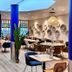 7Hotel&Spa in Illkirch-Graffenstaden restaurant with blue columns, tables, and wall decor