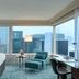JW Marriott Hotel Hong Kong guest room with city skyline views and teal armchair