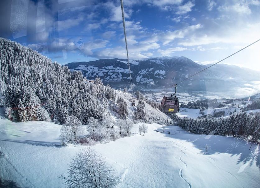 Wohlfühlhotel Schiestl in Fügenberg with a ski lift over snowy mountain slopes and valley views