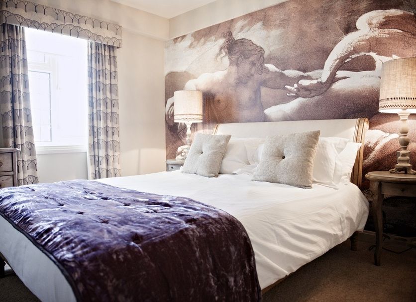 The White Swan Hotel in Stratford-upon-Avon bedroom with horse mural, bedside lamps and plush bed