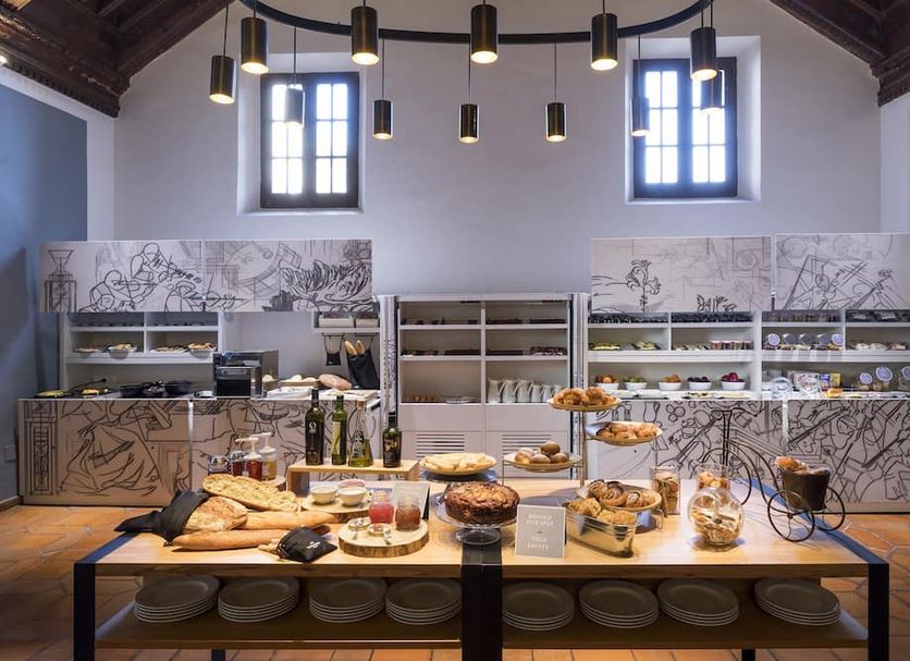 Breakfast buffet at Parador de Cuenca in Cuenca with bread, pastries, fruit and dining tables