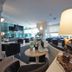 Hotel Europa in Jesolo lobby lounge with seating, tables and large windows