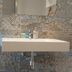 Hotel San Nikolas Sea Views bathroom sink with stone wall and wall-mounted mirror in Hondarribia