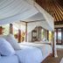 The Ungasan Clifftop Resort in South Kuta villa bedroom with ocean view and canopy bed
