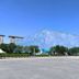 Long Ge Hotel, Beijing: modern hexagonal-patterned building beside a wide paved plaza under blue sky