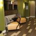 Holiday Inn Express & Suites Huntsville Airport lobby seating area in Madison with hallway to dining space