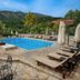 Kaiafas Lake Hotel in Zacháro: outdoor pool with loungers, umbrellas and mountain views
