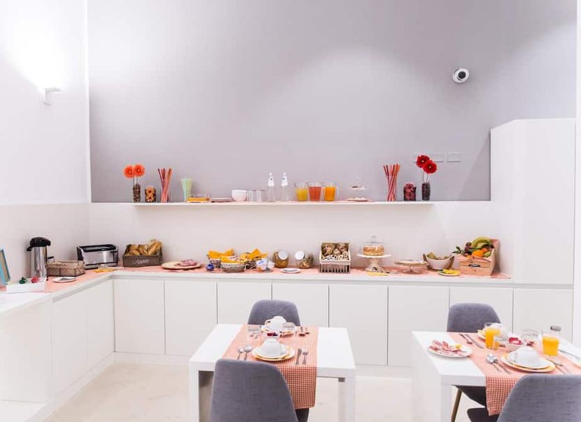Ortigia Bed and Breakfast in Siracusa dining room with buffet breakfast setup and tables