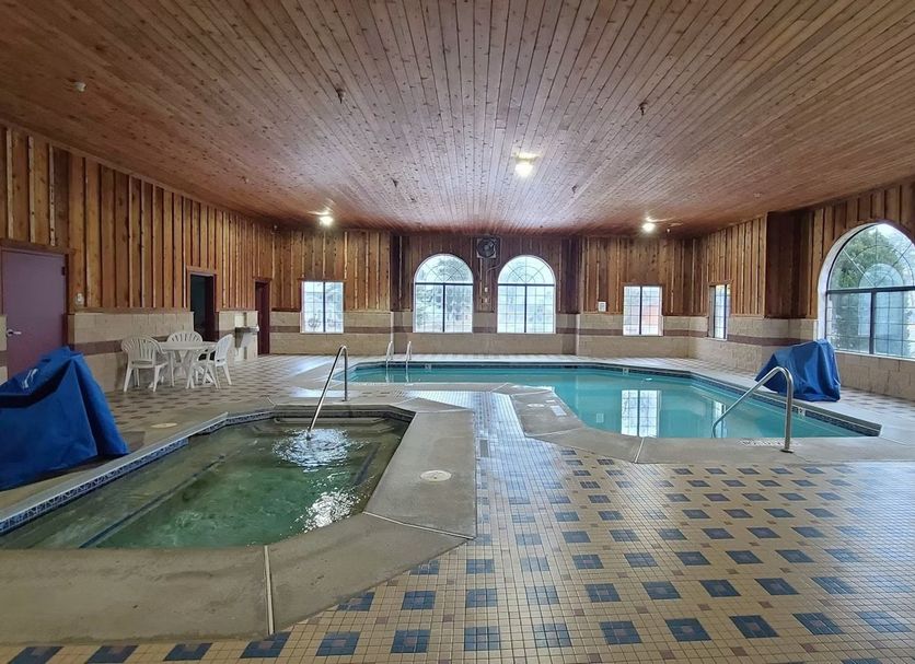 Bay Inn in Tawas City indoor pool with hot tub, arched windows, and tiled deck