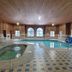 Bay Inn in Tawas City indoor pool with hot tub, arched windows, and tiled deck