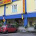 Sun Inns Hotel Lagoon in Petaling Jaya exterior with blue-and-yellow facade and parked cars