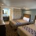 Industry Inn & Suites in La Puente double room with two beds and stone accent wall