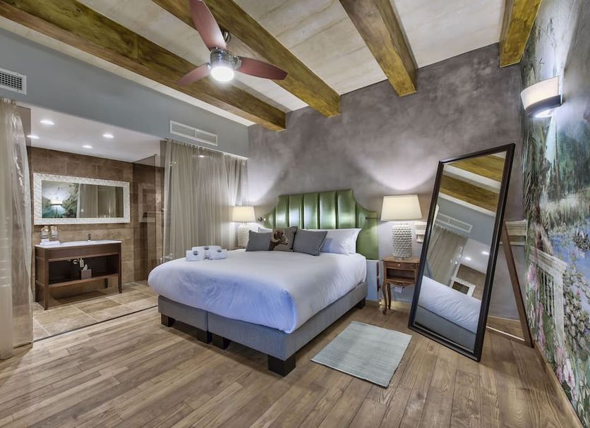 Palazzo Consiglia - Ik Collection room in Valletta with king bed, wood beams, and full-length mirror