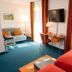 Zollamt Design Hotel Kaiserslautern guest room with bed, desk, TV and large windows