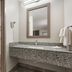 Red Roof Inn Birmingham South bathroom with granite vanity, mirror, toilet and shower in Birmingham