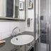Villahotel Vlissingen bathroom with stone vanity, sink, mirror and glass shower in Vlissingen