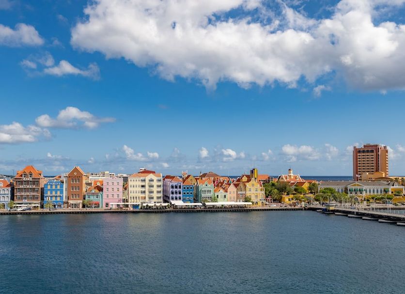 Harbor Hotel & Casino Curacao in Willemstad with waterfront view of colorful waterfront buildings and blue sky