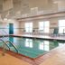 Country Inn & Suites by Radisson, Effingham, IL indoor pool with lounge chairs and large windows