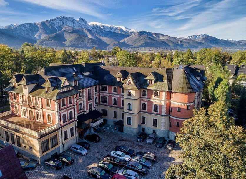 Grand Hotel Stamary in Zakopane with mountain views and a courtyard parking area