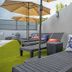 Casa Toñita in Levittown: rooftop lounge chairs with umbrellas and ship-wheel pillows on artificial grass