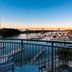 SpringHill Suites by Marriott Orange Beach at The Wharf balcony view of marina and bridge at sunset
