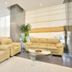 Barakat Burhan Hotel in Mecca lobby with beige sofas, glass coffee table and potted plants