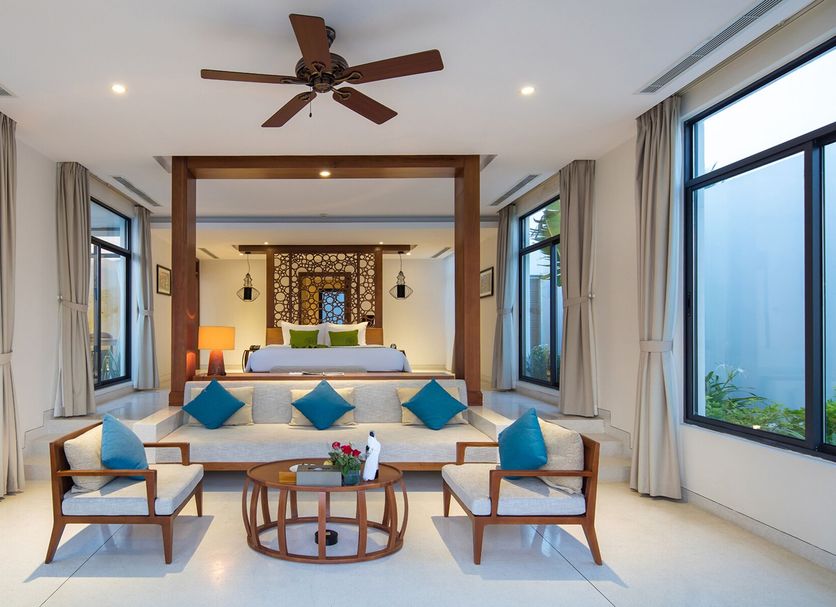 Cam Ranh Riviera Beach Resort & Spa in Nha Trang, airy suite with king bed and ocean-view windows