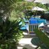Colony Hotel & Cabana Club, Delray Beach: tropical patio with blue lounge chairs and white umbrellas