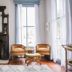 Carr Mansion in Galveston: elegant parlor with ornate fireplace, twin chairs, coffee table, and tall windows