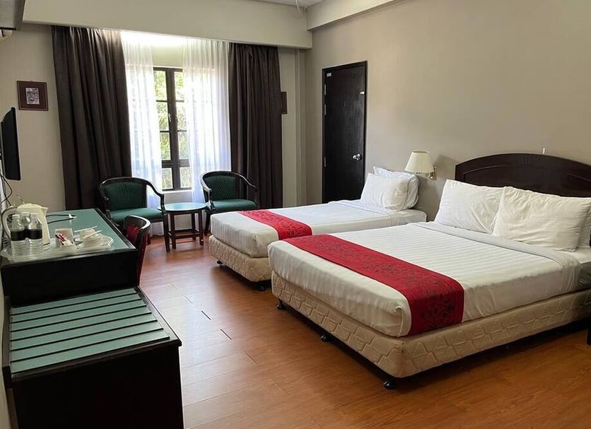 Hotel Seri Malaysia Genting Highlands room with two double beds and a window seating area