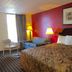 Parkway Inn Morristown guest room with bed, sofa, lamps, and chair by the window