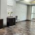Baymont by Wyndham San Antonio Airport lobby with textured white walls, cabinets, chair and tiled floor