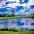 Palac Krobielowice in Kąty Wrocławskie with a tranquil pond reflecting clouds and lush greenery