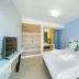 Thassos Olivia Resort in Potos bedroom with king bed, TV, wardrobe and wall-mounted air conditioner