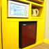 Time Motel in Gyeongju: yellow kitchenette nook with microwave, mini fridge, and electric kettle