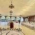 The Q Hotel Tagaytay ballroom with chandeliers, arched windows, and long banquet table rows