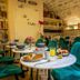 Hotel Romance Malesherbes by Patrick Hayat café with green chairs and breakfast tables in Paris