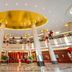 White Dolphin Hotel in Qinzhou lobby with grand columns, gold ceiling, and circular chandelier.