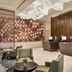Oakwood Residence Saigon lobby in Ho Chi Minh City with reception desks, lounge seating and floral wall art