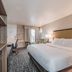 Clarion Pointe Winston - Salem Downtown guest room with king bed, desk and window seating in Winston-Salem