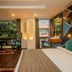 Hotel Jagjeet in Darjeeling guest room with bed, seating nook, and large windows