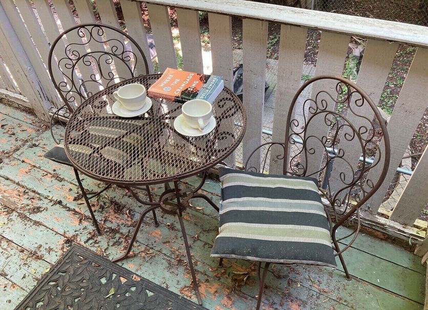 The Villa Toscana Chicago patio table and chairs with coffee cups and striped cushion