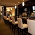 Holiday Inn & Suites Red Deer South by IHG bar with high stools and TVs in Red Deer