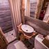 Cottage Inn At Lake Tahoe in Tahoe City bathroom with rustic wood walls, vessel sink, and stone shower
