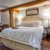 5 Ojo Inn Bed & Breakfast in Eureka Springs: cozy bedroom with king bed, armchair, and warm lighting